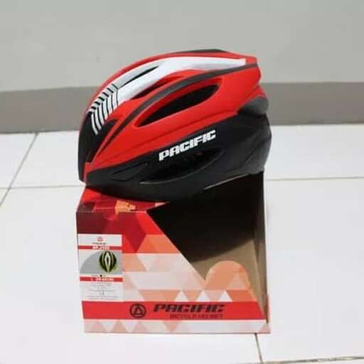 a red and black helmet sitting on top of a box.