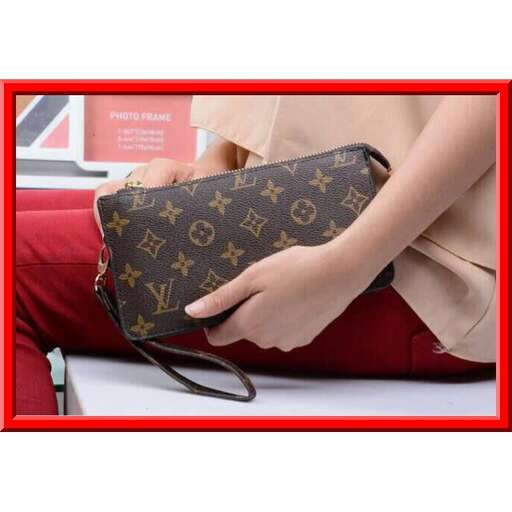 a woman holding a purse with a red frame.