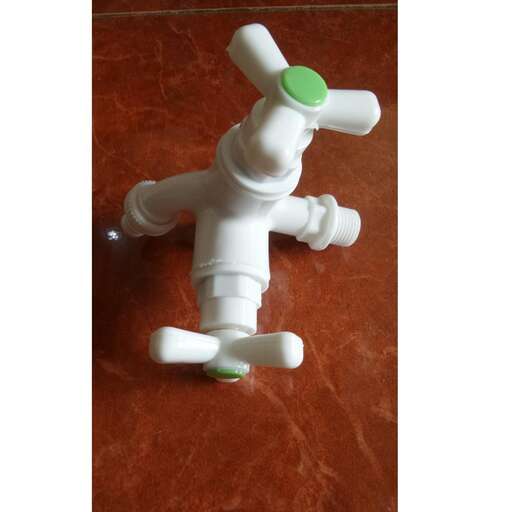 a white plastic toy with a green top and white plastic head.