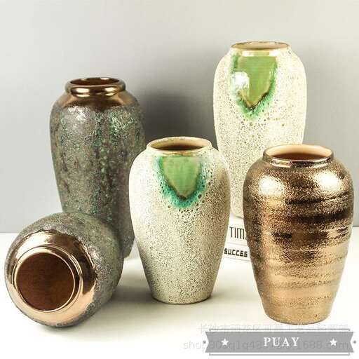 a group of vases sitting on top of a table.