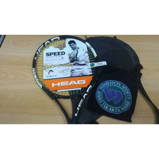 a tennis racket with a tennis ball and a hat.