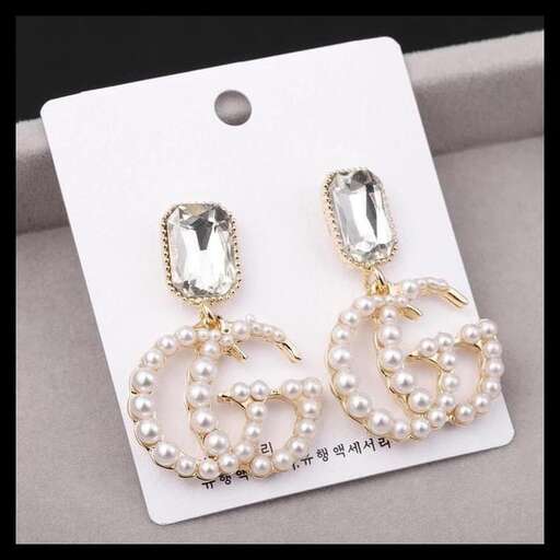 a pair of earrings with a pair of diamond earrings.