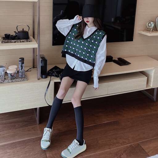 a girl sitting on a bench in front of a tv.