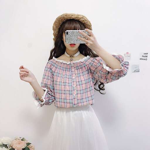 a girl in a hat and a straw hat is holding a cell phone.