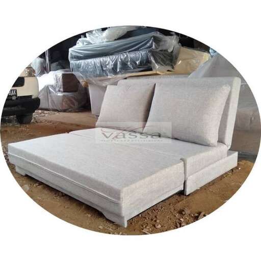 a white bed sitting on top of a wooden floor.
