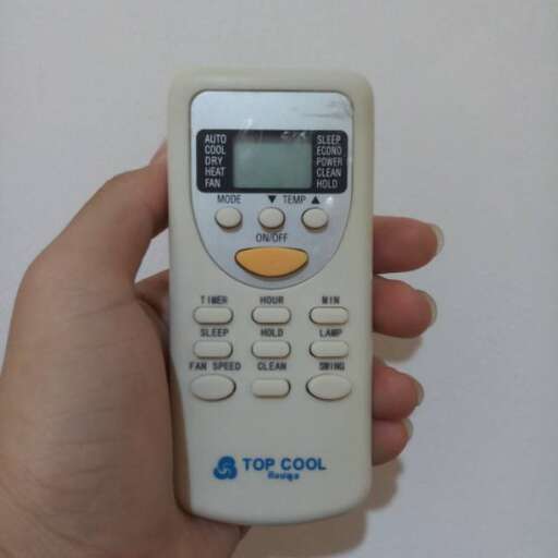 a person holding a remote control in their hand.
