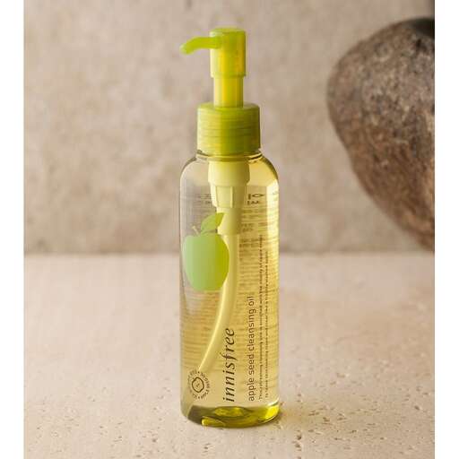 a bottle of olive oil with a green cork in the middle.