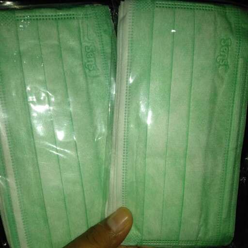 a person holding a green case with a white towel.