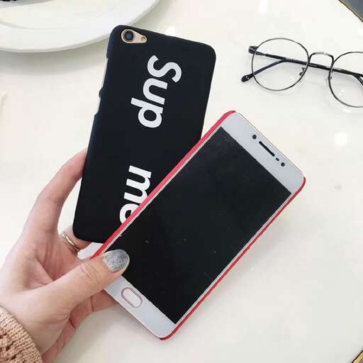 a person holding a cell phone in their hand.