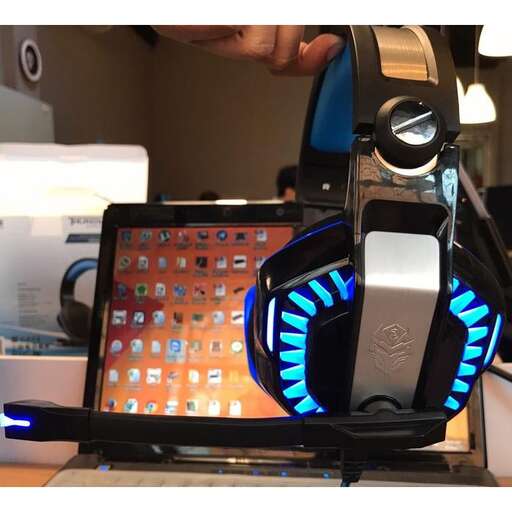 a laptop computer with headphones on and a headphone on it.