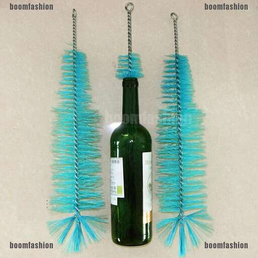 a picture of some blue feathers hanging from a wine bottle.