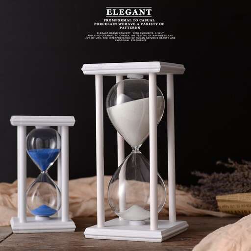 a hourglass with a white sand and a blue heart.
