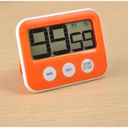 a digital clock with a digital time displayed on a table.