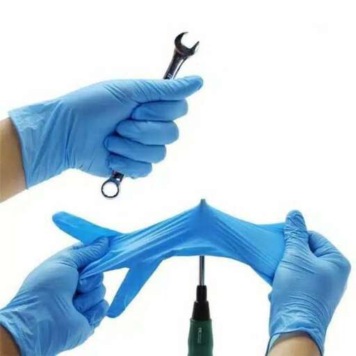 a person in blue gloves holding a syringe and a needle.