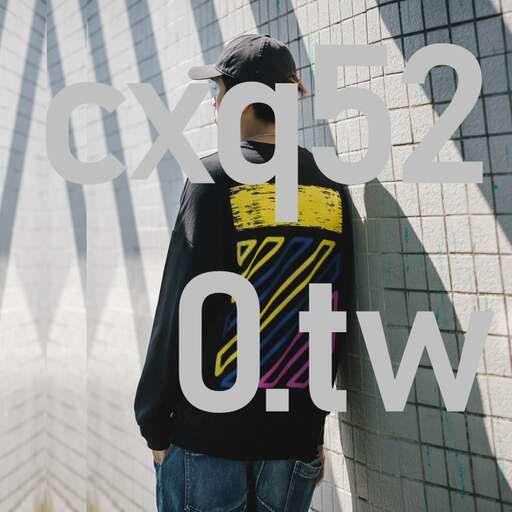 a man standing against a wall with a large window in the background.