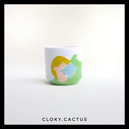 a mug with a woman in a green and blue dress