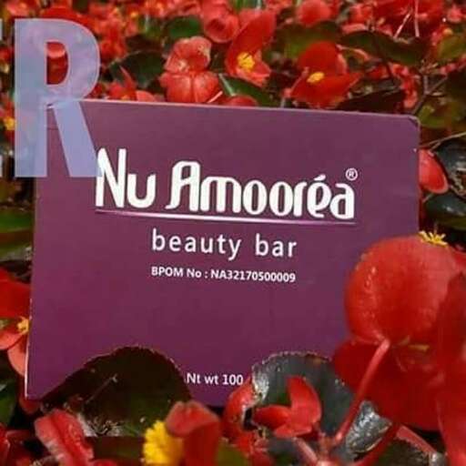 a sign in a garden of flowers