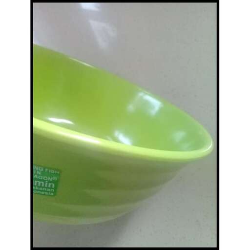 a green glass bowl on a white counter.