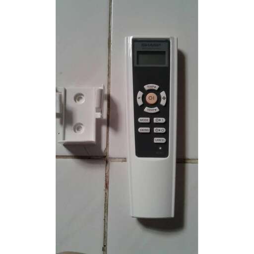 a white phone mounted to a wall with a white switch.
