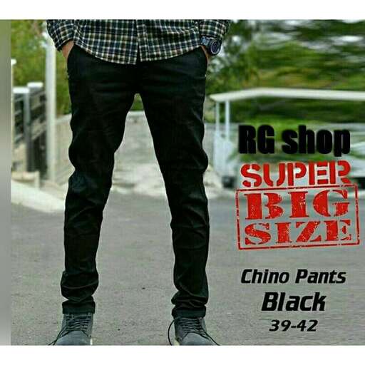 a man wearing black jeans and a plaid shirt.