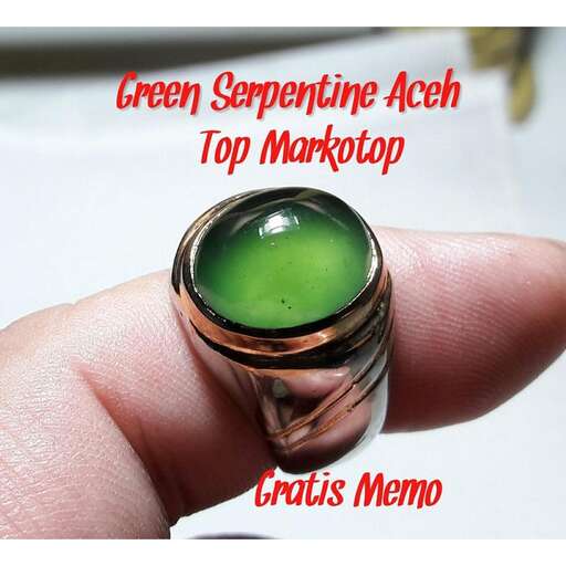 a green glass ring with a green glass top.
