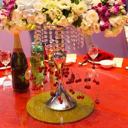 a table topped with a vase filled with flowers.