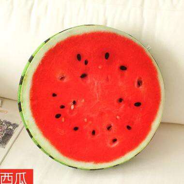a watermelon cut in half on a bed