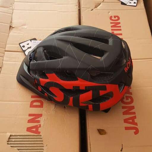 a helmet is sitting on top of a cardboard box.