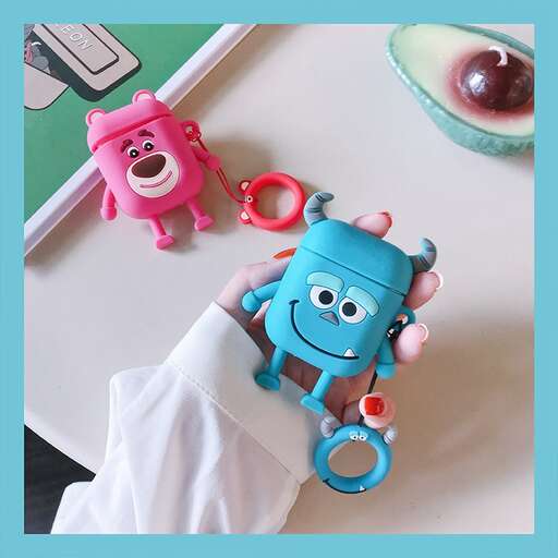 a blue monster with a pink nose and a blue shirt.