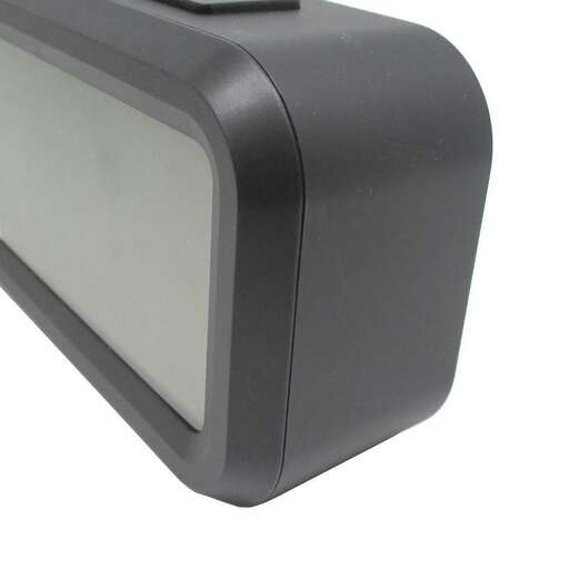 a black alarm clock with a white background.