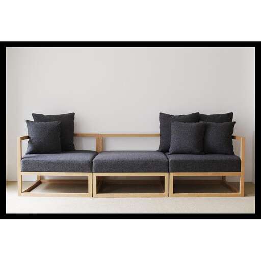 a modern sofa with a wooden frame.