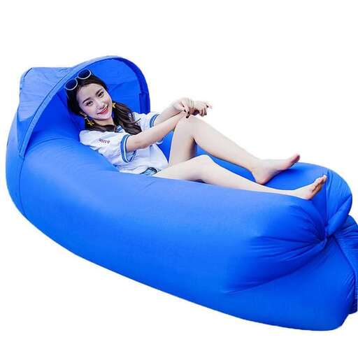 a girl is laying on a bean bag chair.