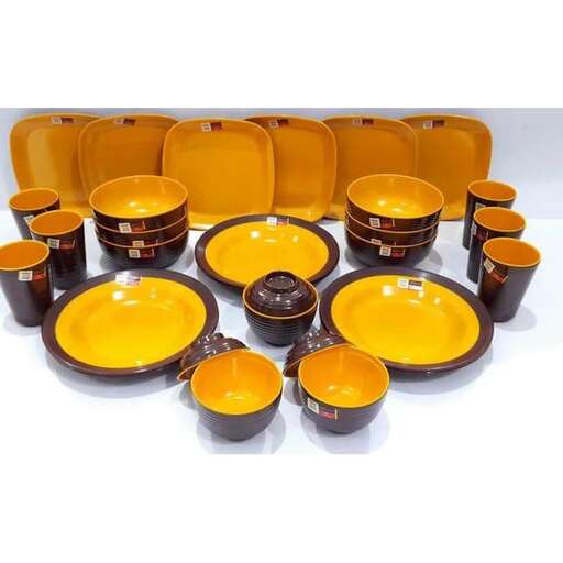 a set of orange and black bowls and plates.