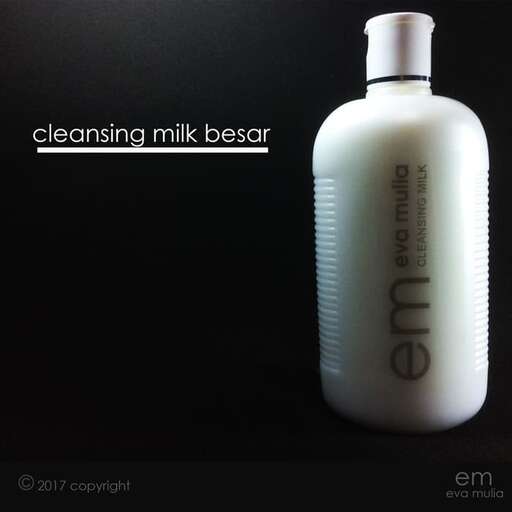 a bottle of milk sitting on top of a black surface.