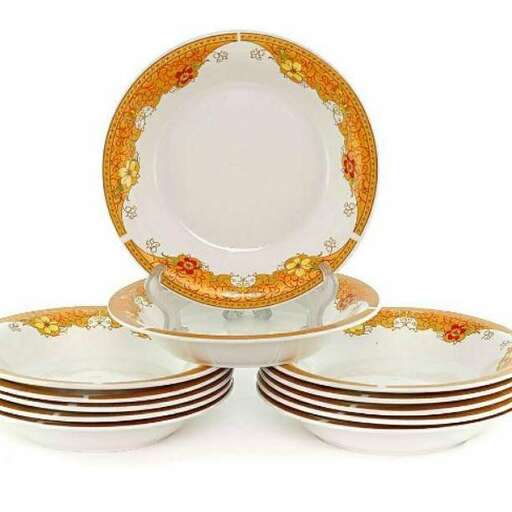 a set of plates with gold and red diamonds.