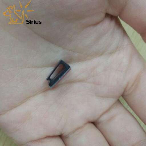 a small black button in the middle of the hand