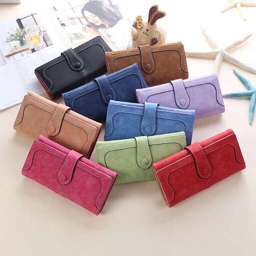 a stack of colorful purses sitting on a table.