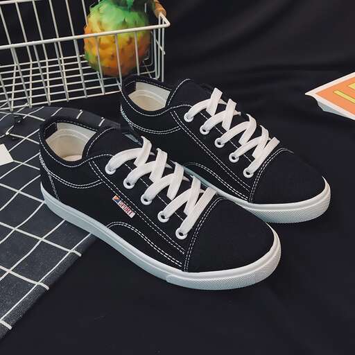 a pair of black and white sneakers with white laces.