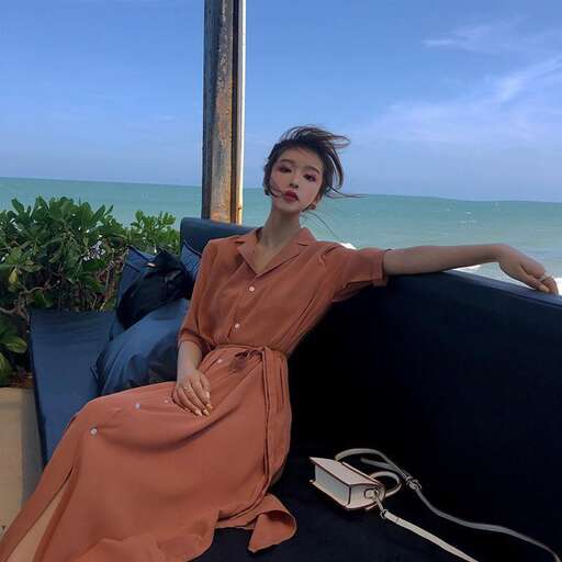 a model in a long brown dress and a long brown dress