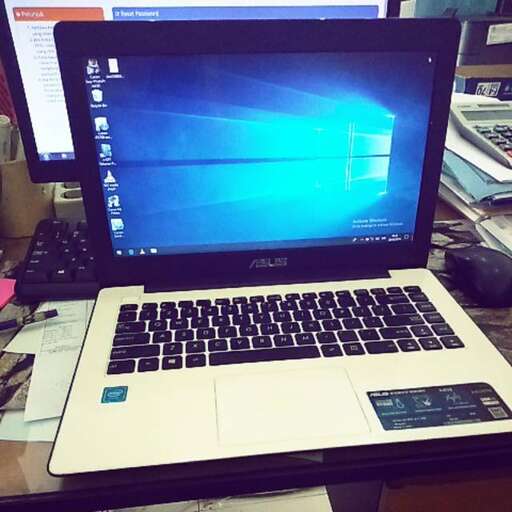 a laptop computer sitting on a desk.