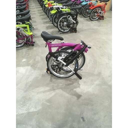 a bicycle with a pink frame and black seat.
