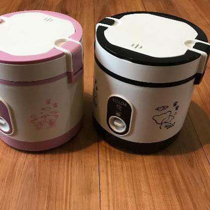 a toaster and a cup of tea on a wooden floor.