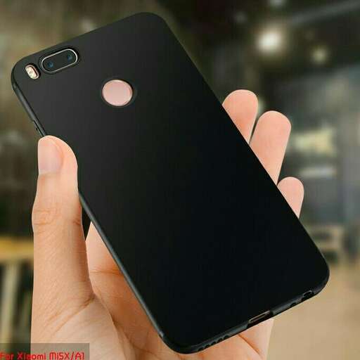 a person holding a black iphone in their hand.