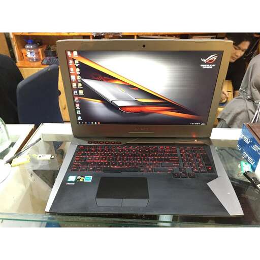 a laptop computer sitting on top of a glass table.