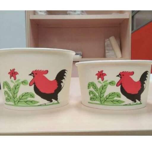 a pair of bowls with roosters on them.