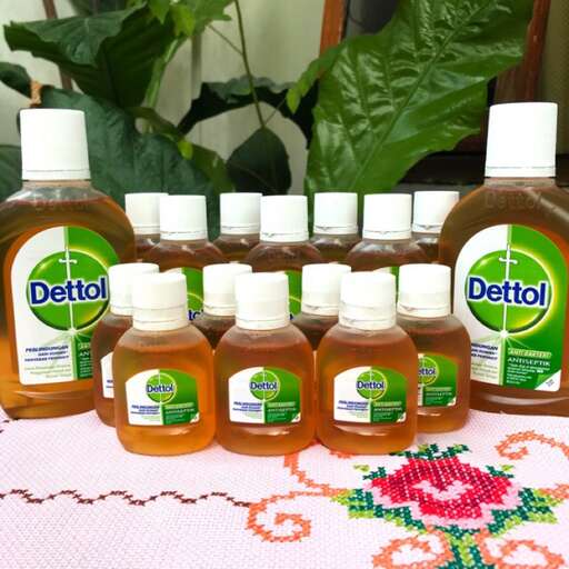 the bottles of cleaners are lined up on a table.