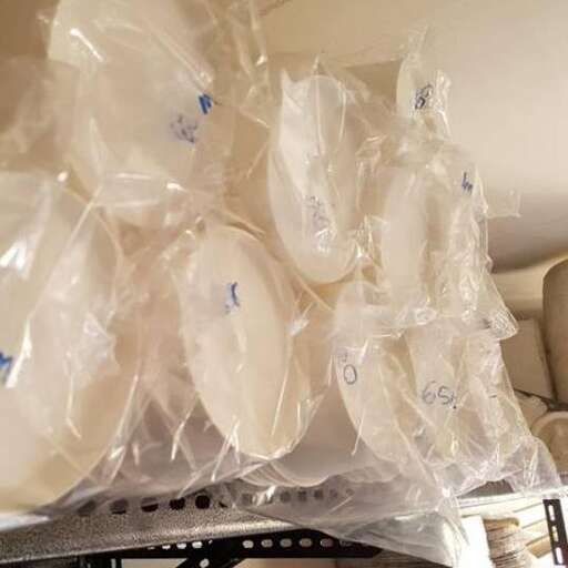 a bunch of plastic bags are stacked on a table.