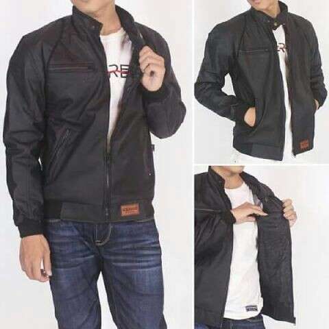 a black leather jacket with a white t - shirt underneath.