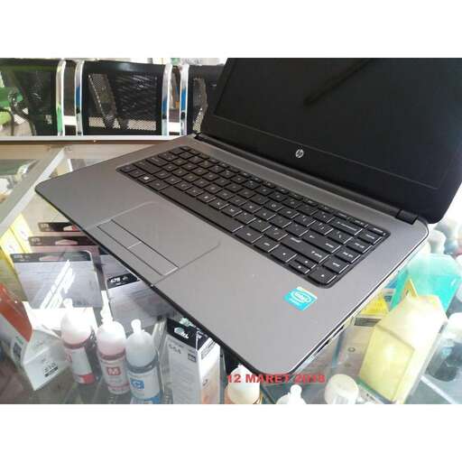a laptop computer sitting on top of a glass shelf.