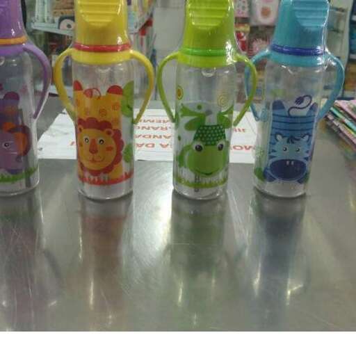 a table with three colorful bottles on it.